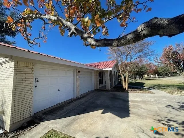 a view of a backyard with a large tree