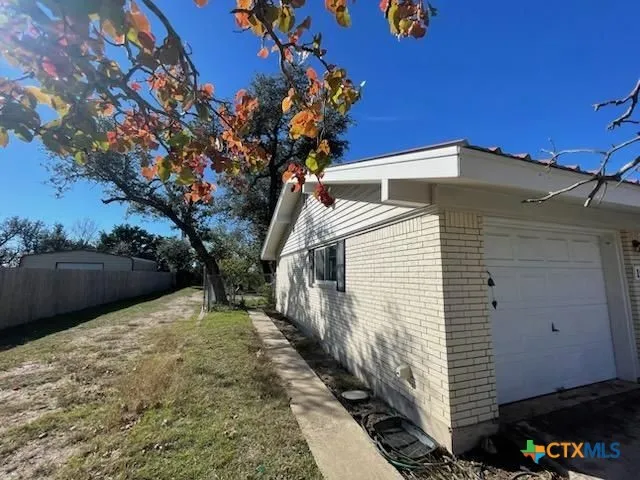 a view of a house with a backyard