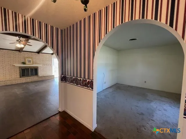 an entryway in a hall with wooden floor