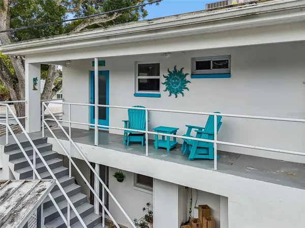 a view of a balcony with chairs