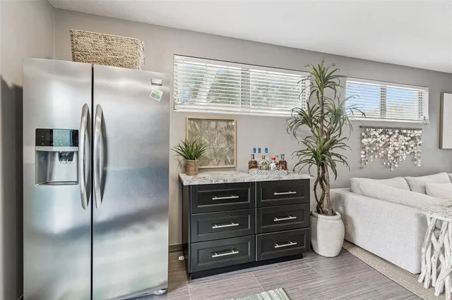 a bathroom with a sink a mirror and a painting on the wall