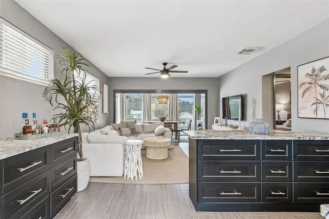 a kitchen with stainless steel appliances granite countertop a sink and a refrigerator