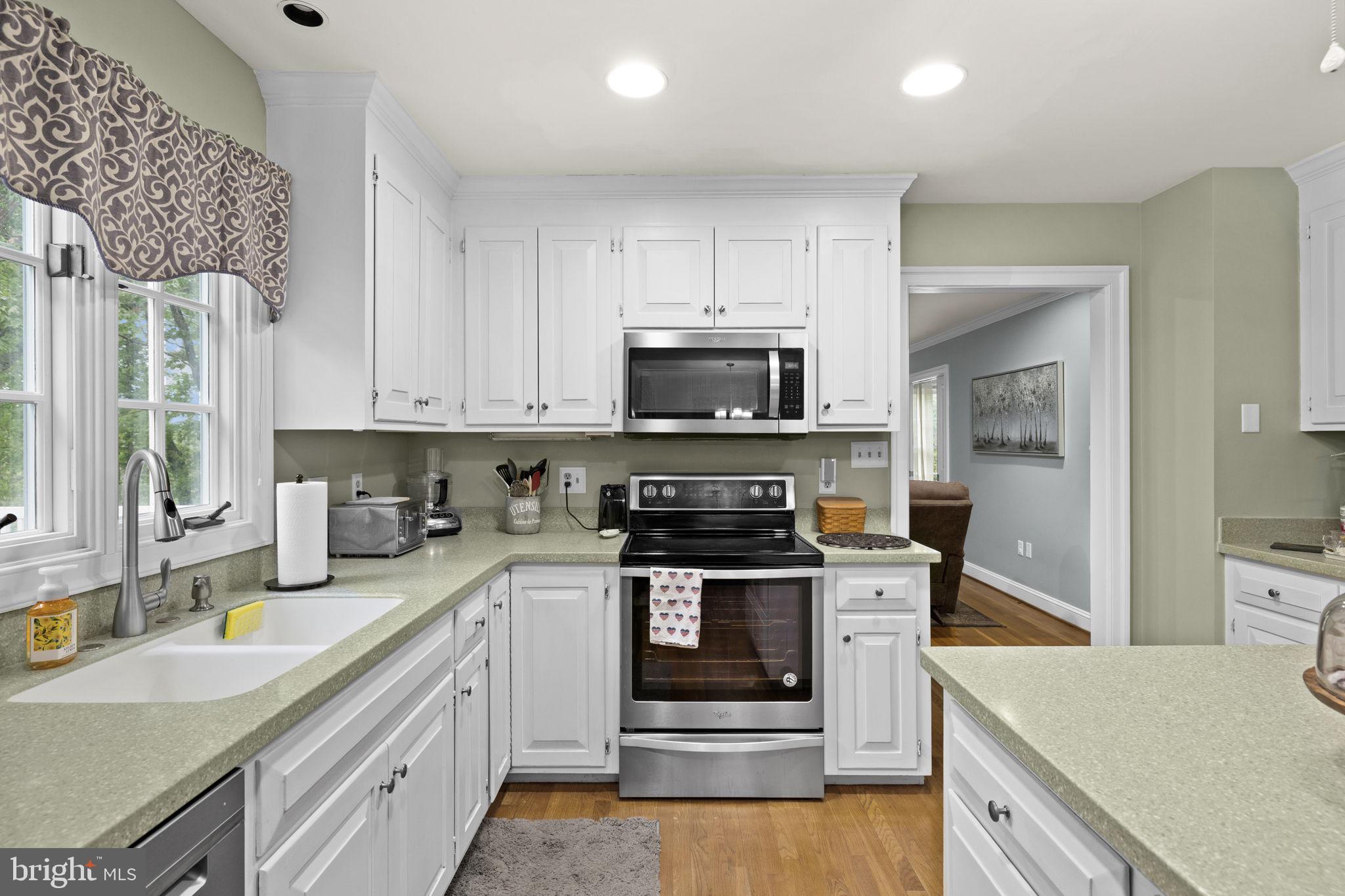 1942 Bibb Store Road Louisa, VA 23093 - Photo 13 of 61 a kitchen with stainless steel appliances granite countertop a stove a sink and a microwave