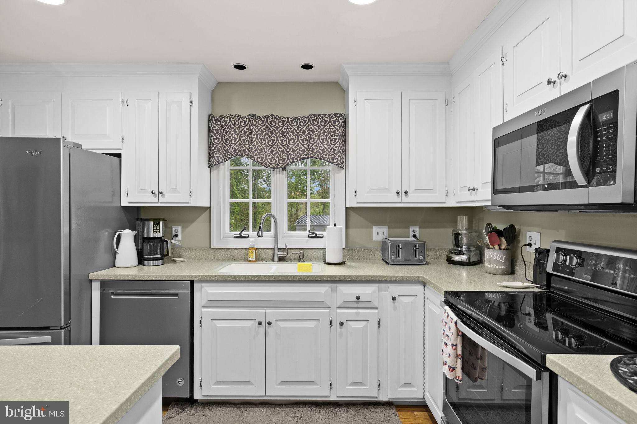 1942 Bibb Store Road Louisa, VA 23093 - Photo 15 of 61 a kitchen with granite countertop white cabinets white stainless steel appliances and a sink