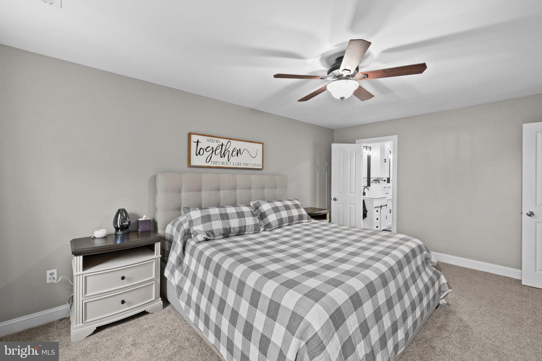 1942 Bibb Store Road Louisa, VA 23093 - Photo 25 of 61 a bedroom with a bed and a chandelier
