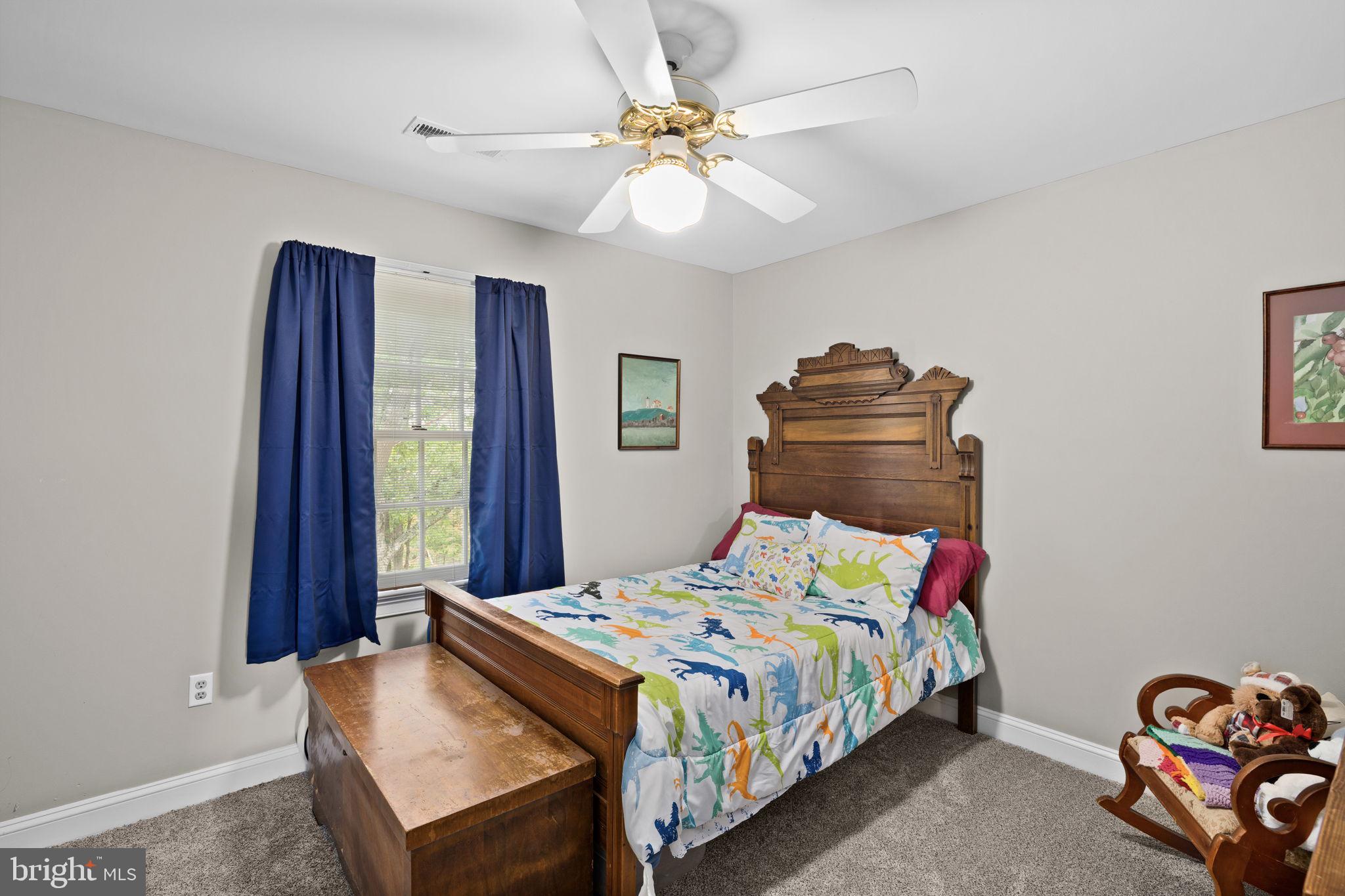 1942 Bibb Store Road Louisa, VA 23093 - Photo 32 of 61 a bedroom with a bed and a chandelier