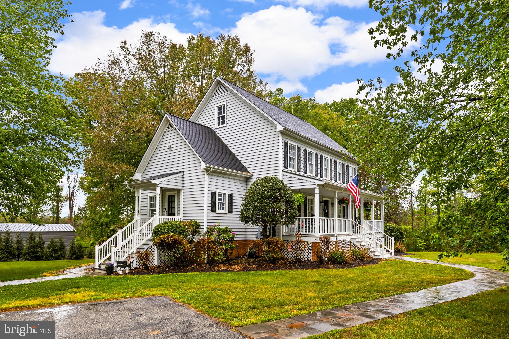 1942 Bibb Store Road Louisa, VA 23093 - Photo 4 of 61 a view of a house with a big yard and potted plants and large trees