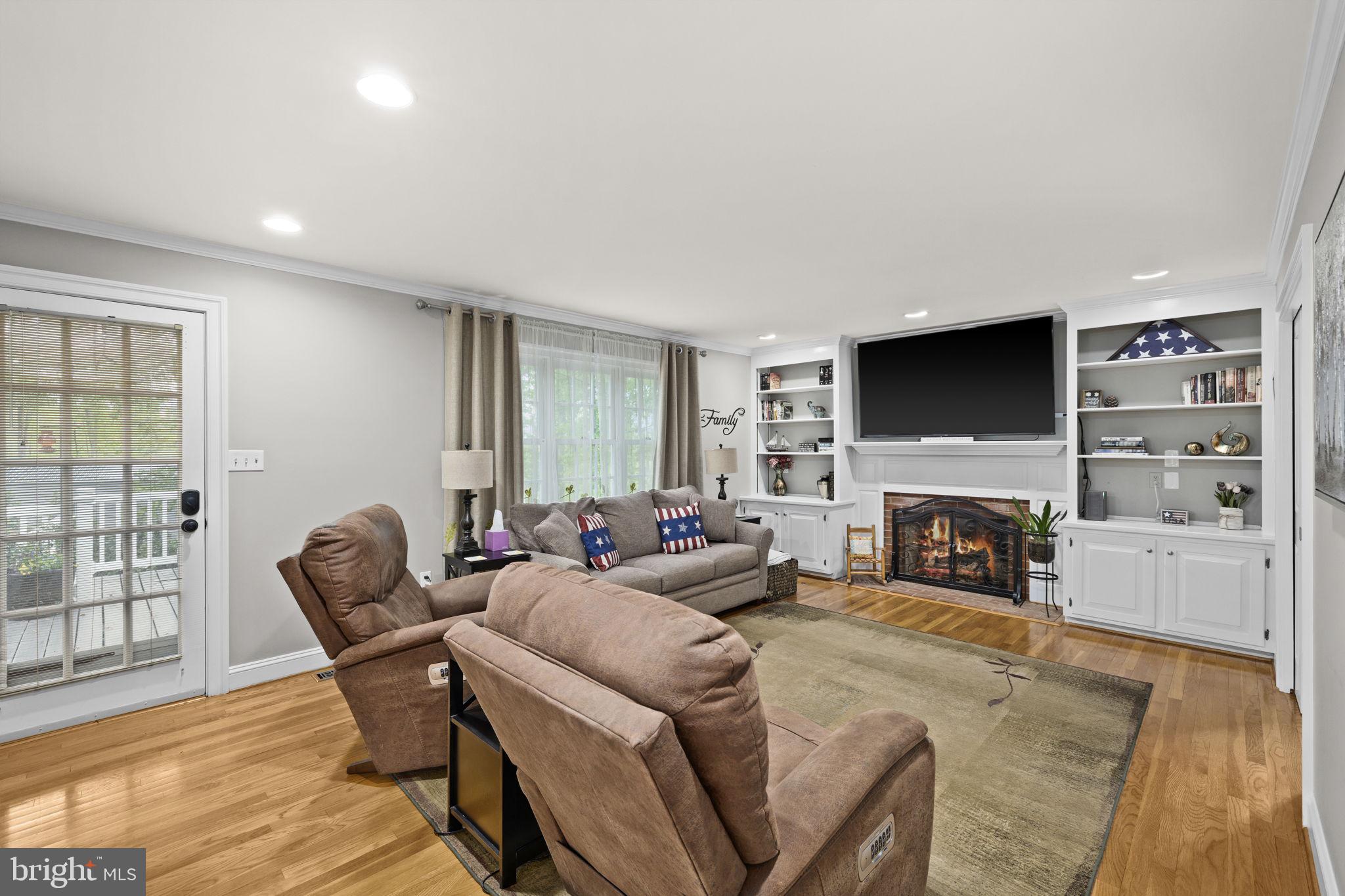 1942 Bibb Store Road Louisa, VA 23093 - Photo 8 of 61 a living room with furniture a fireplace and a flat screen tv