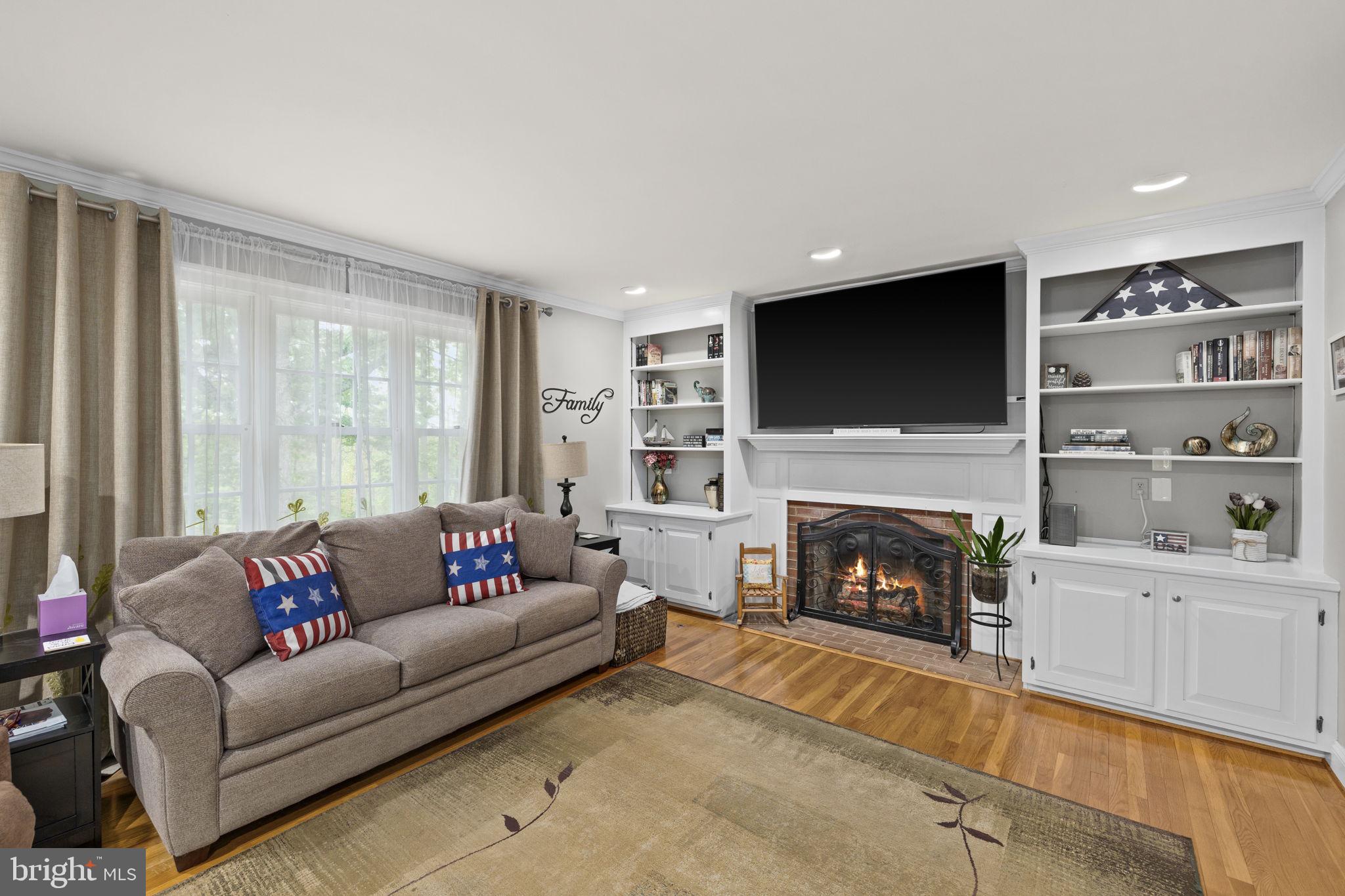 1942 Bibb Store Road Louisa, VA 23093 - Photo 10 of 61 a living room with furniture a fireplace and a flat screen tv