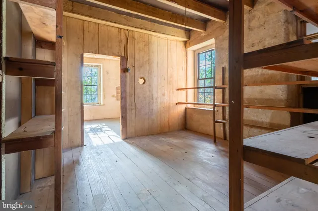 a view of a hallway with wooden walls and entryway