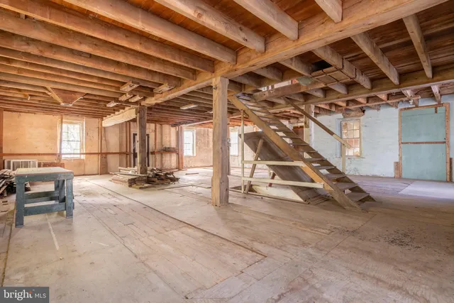 a view of a room with wooden floor and windows