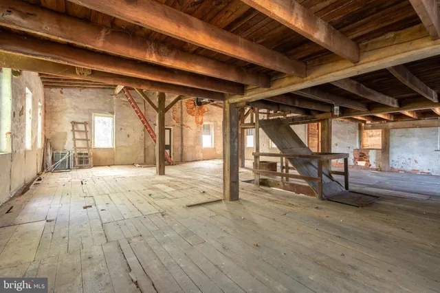 a view of a room with wooden floors