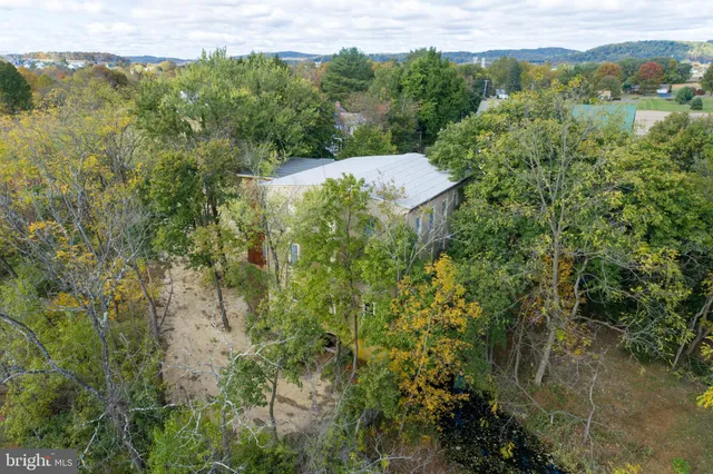 an aerial view of lake and residential houses with outdoor space and river