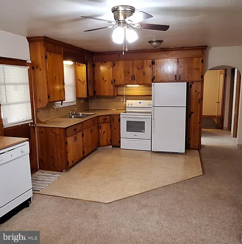 a kitchen with refrigerator stove and cabinets