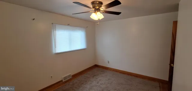 a view of an empty room and a window