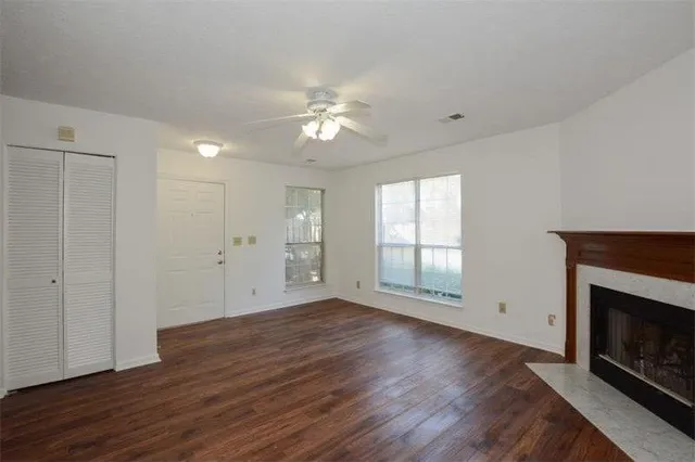 a kitchen that has a lot of cabinets and wooden floor
