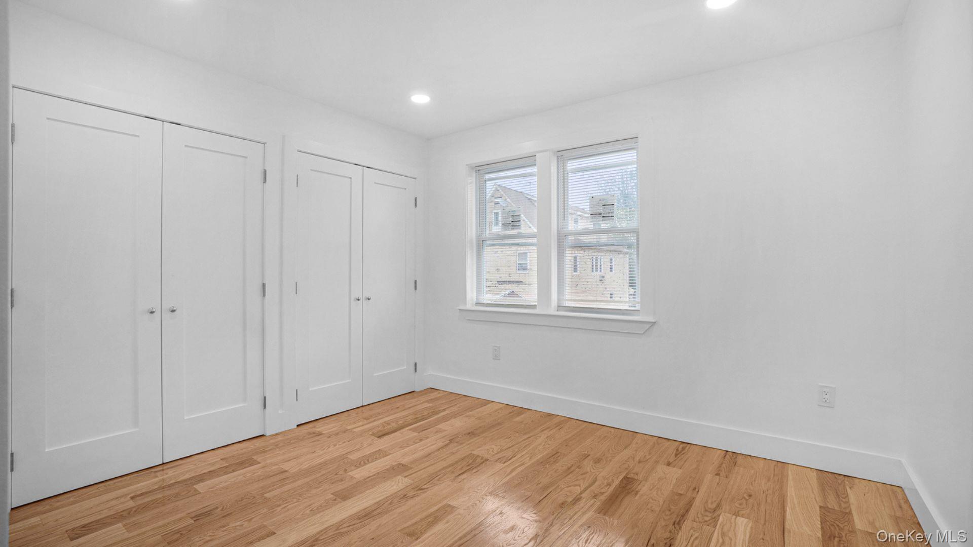 3968 Duryea Avenue Bronx, NY 10466 - Photo 19 of 30 Unfurnished bedroom featuring two closets, light wood-style flooring, and recessed lighting