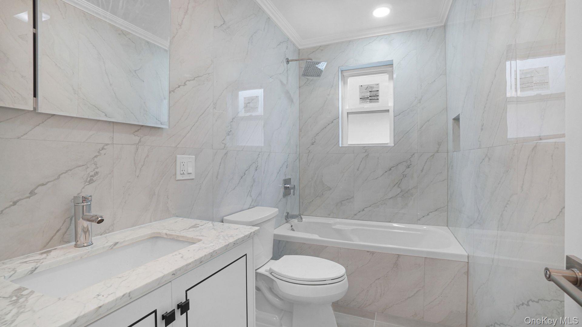 3968 Duryea Avenue Bronx, NY 10466 - Photo 24 of 30 Full bath with tile walls, crown molding, vanity, and tiled shower / bath