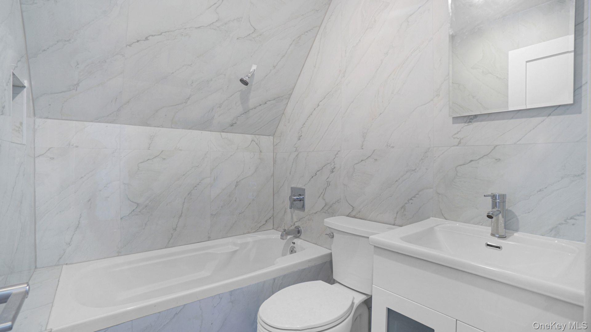 3968 Duryea Avenue Bronx, NY 10466 - Photo 25 of 30 Full bathroom featuring tile walls, vanity, and a combined bath / shower with marble appearance