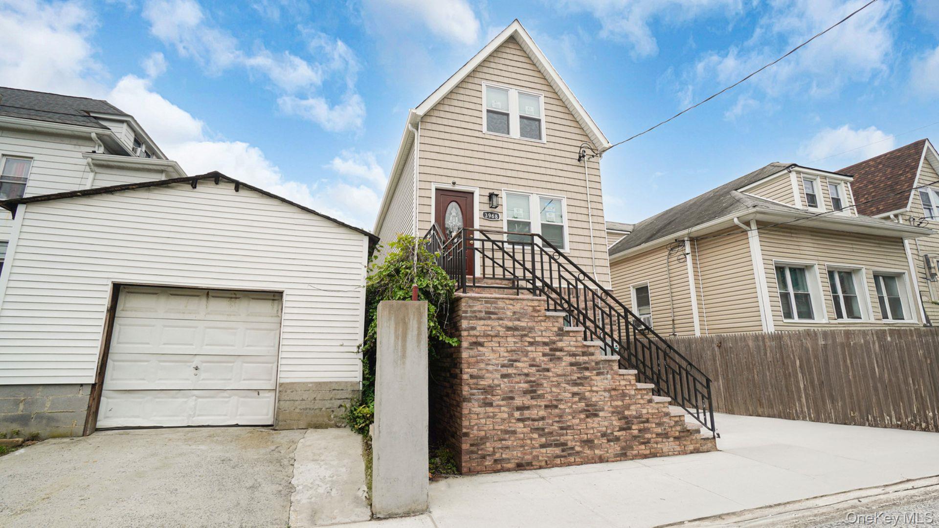 3968 Duryea Avenue Bronx, NY 10466 - Photo 27 of 30 View of front of property with an outdoor structure, a garage, concrete driveway, and stairway