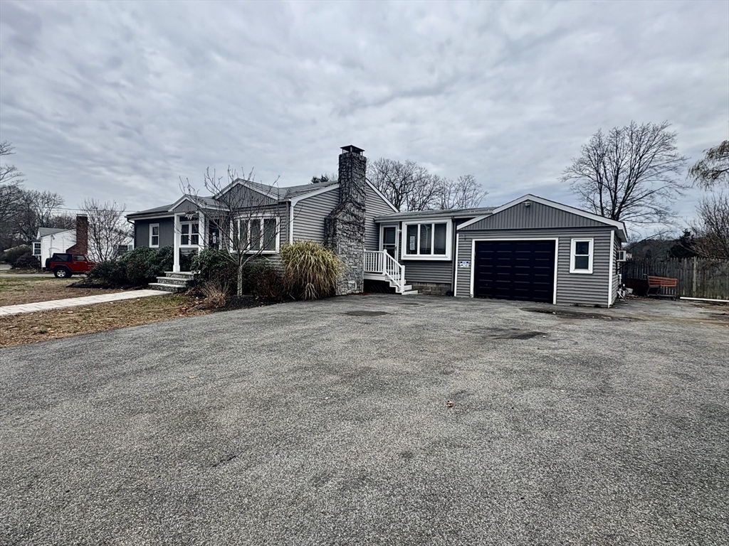 5 Wennerberg Road Middleton, MA 01949 - Photo 3 of 7 a front view of a house with a yard and garage