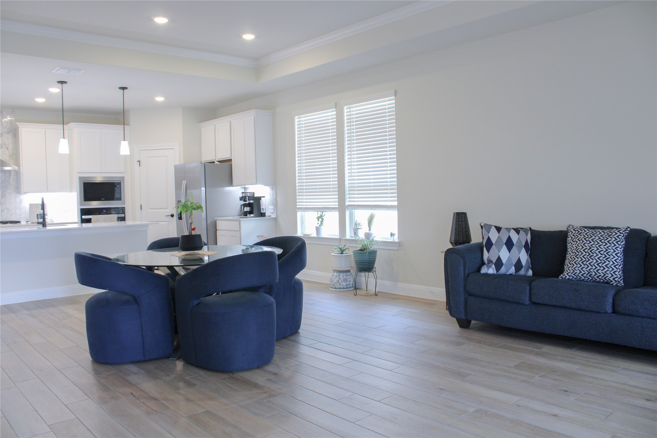 181 Tree Nut Loop Buda, TX 78610 - Photo 17 of 33 Gleaming wood-look tile flooring runs through this airy, open-concept living space with crown molding.