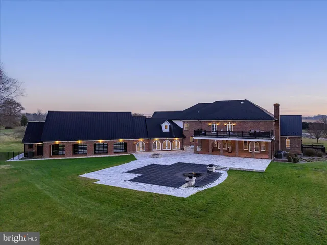 a view of a big room with wooden floor and a kitchen