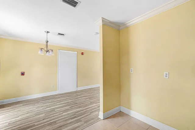 a view of a room with wooden floor