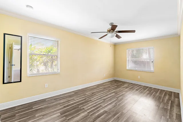 a view of room with window and wooden floor