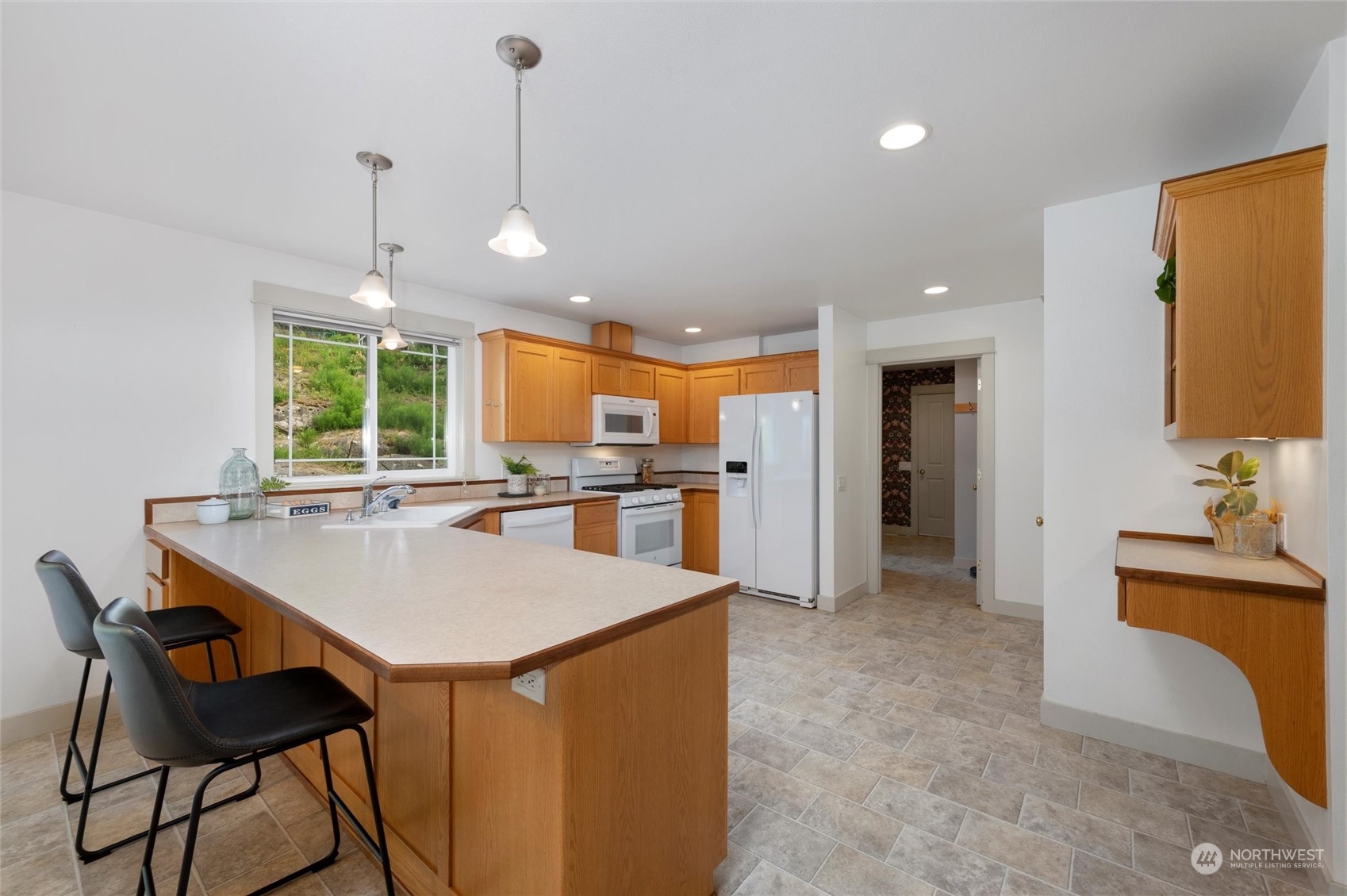 3703 Fielding Avenue Bellingham, WA 98229 - Photo 7 of 40 a kitchen with stainless steel appliances kitchen island granite countertop a sink and a refrigerator
