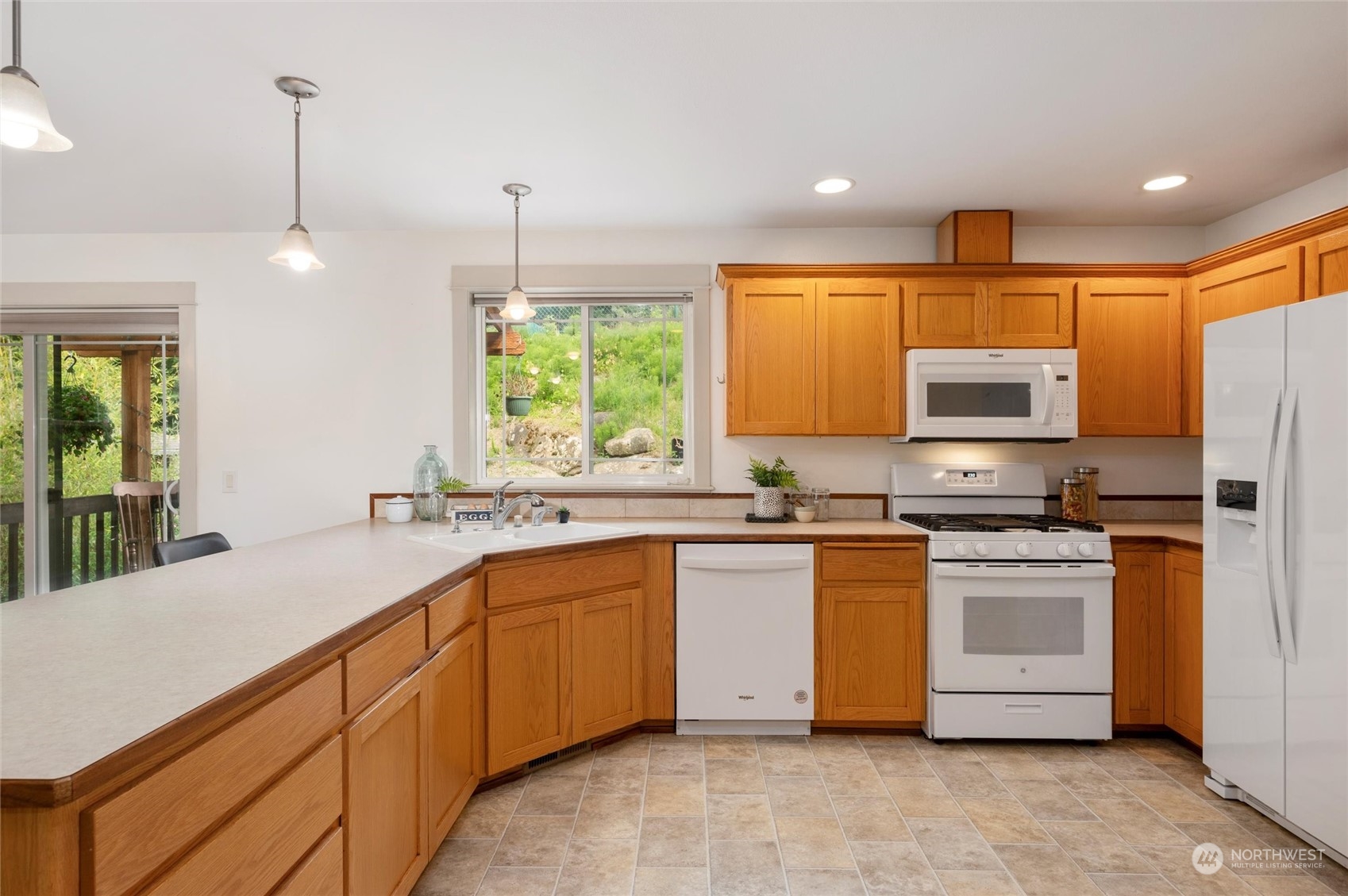3703 Fielding Avenue Bellingham, WA 98229 - Photo 8 of 40 a kitchen with stainless steel appliances granite countertop a stove a sink a refrigerator and a microwave