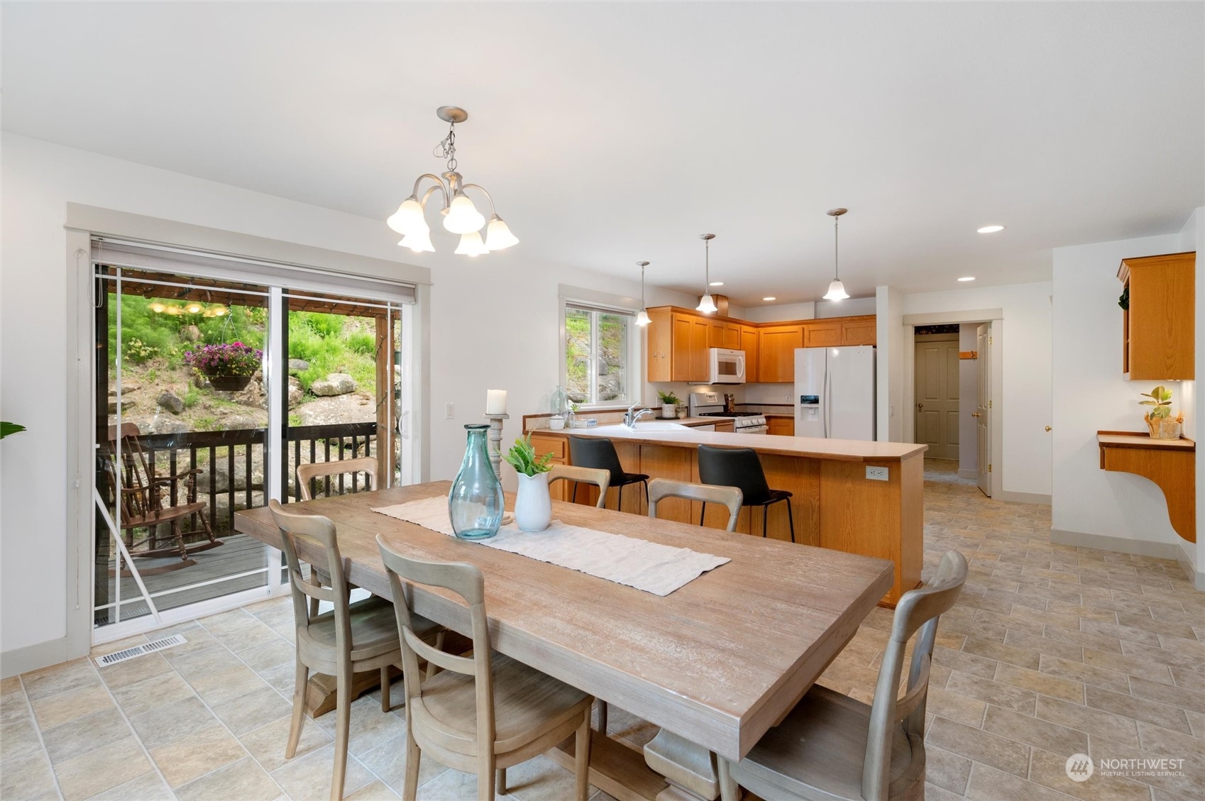 3703 Fielding Avenue Bellingham, WA 98229 - Photo 10 of 40 a dining room with stainless steel appliances kitchen island granite countertop a dining table chairs and a refrigerator