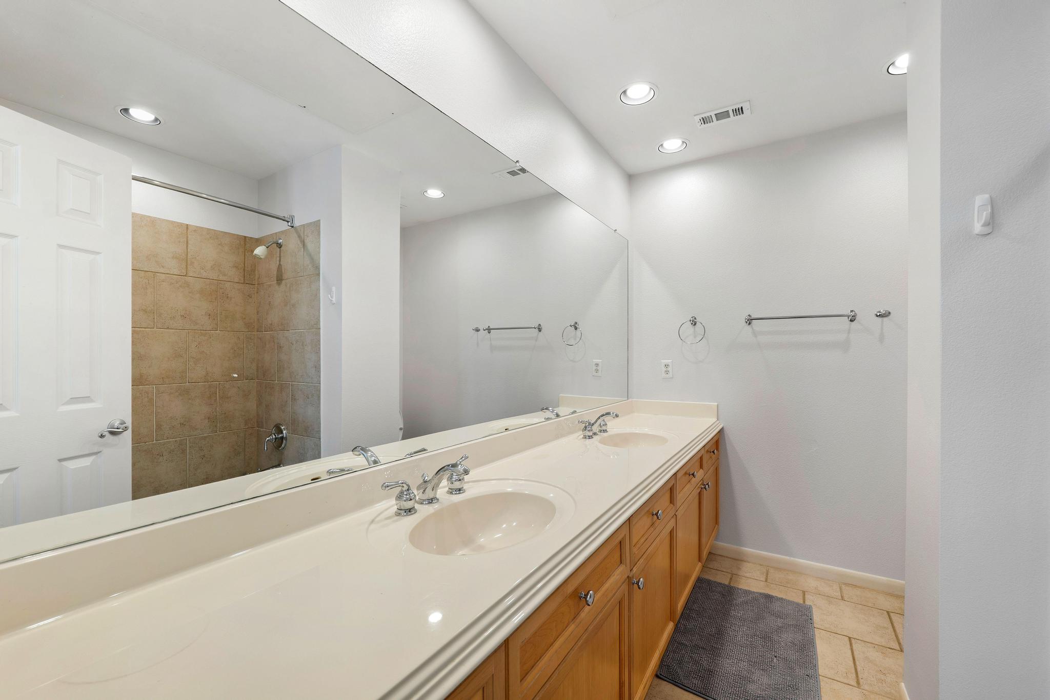 2918 Ranch Road 620, Unit J162 Austin, TX 78734 - Photo 18 of 26 Second bath with tub/shower, Double vanity with integrated sinks and chrome fixtures