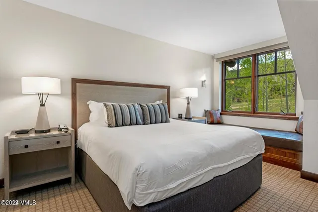 a bedroom with a bed and a window