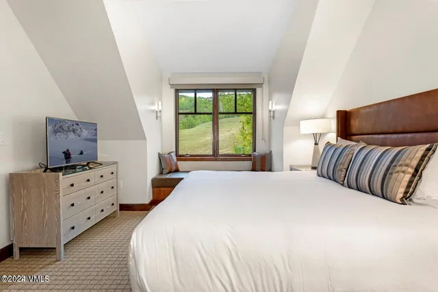 a bedroom with a bed and window