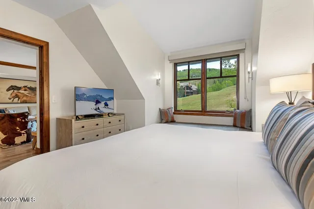 a view of a bedroom with furniture and windows