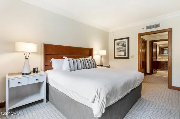 a bedroom with a bed and a lamp