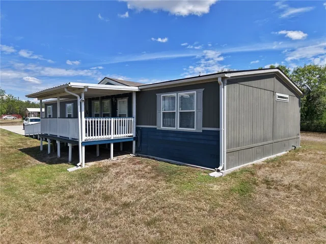 a aerial view of a house with a yard