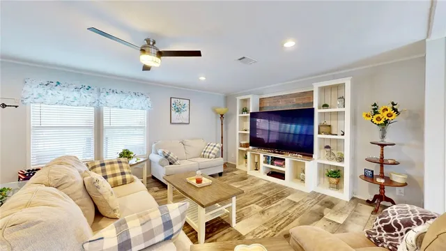 a bedroom with furniture and a flat screen tv