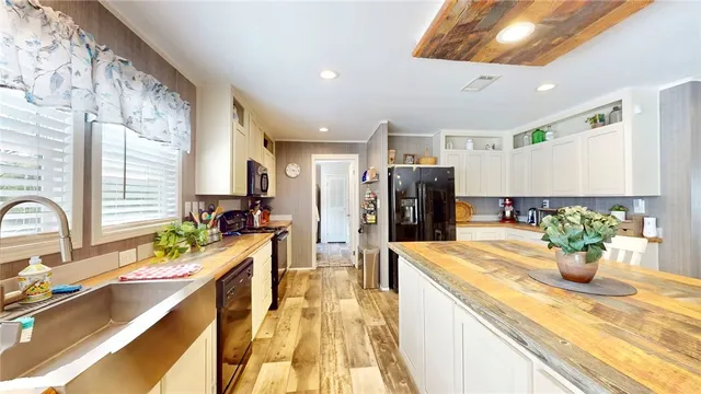 a large kitchen with a table and chairs