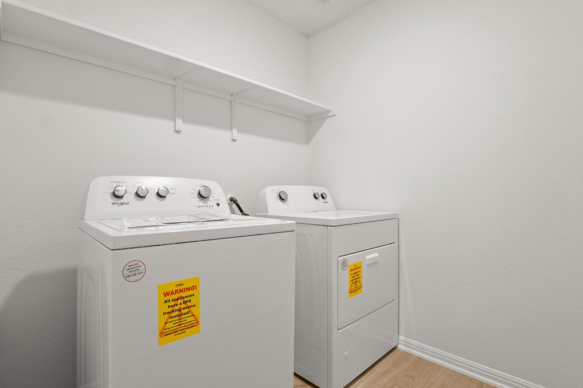 2408 Bronc Buster Way Leander, TX 78641 - Photo 10 of 24 a utility room with dryer and washer