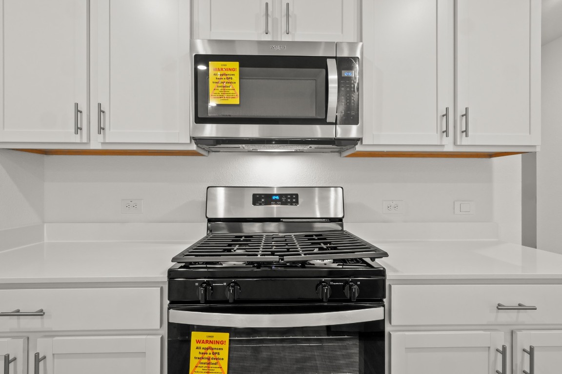 2408 Bronc Buster Way Leander, TX 78641 - Photo 11 of 24 a stove top oven sitting inside of a kitchen