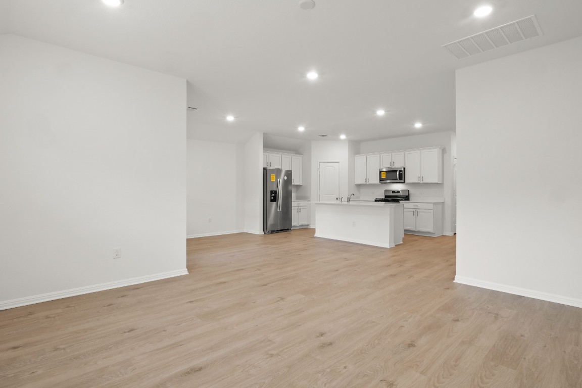 2408 Bronc Buster Way Leander, TX 78641 - Photo 13 of 24 a view of a kitchen with a sink and a refrigerator