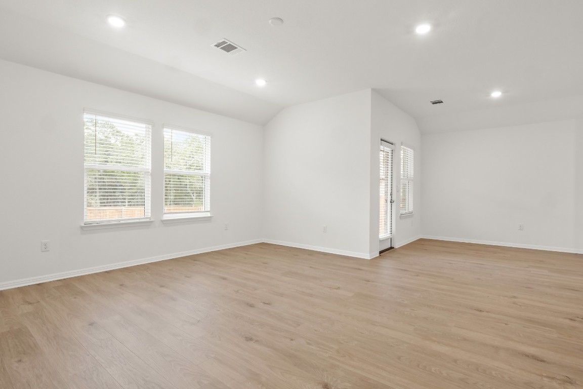 2408 Bronc Buster Way Leander, TX 78641 - Photo 14 of 24 an empty room with wooden floor and windows