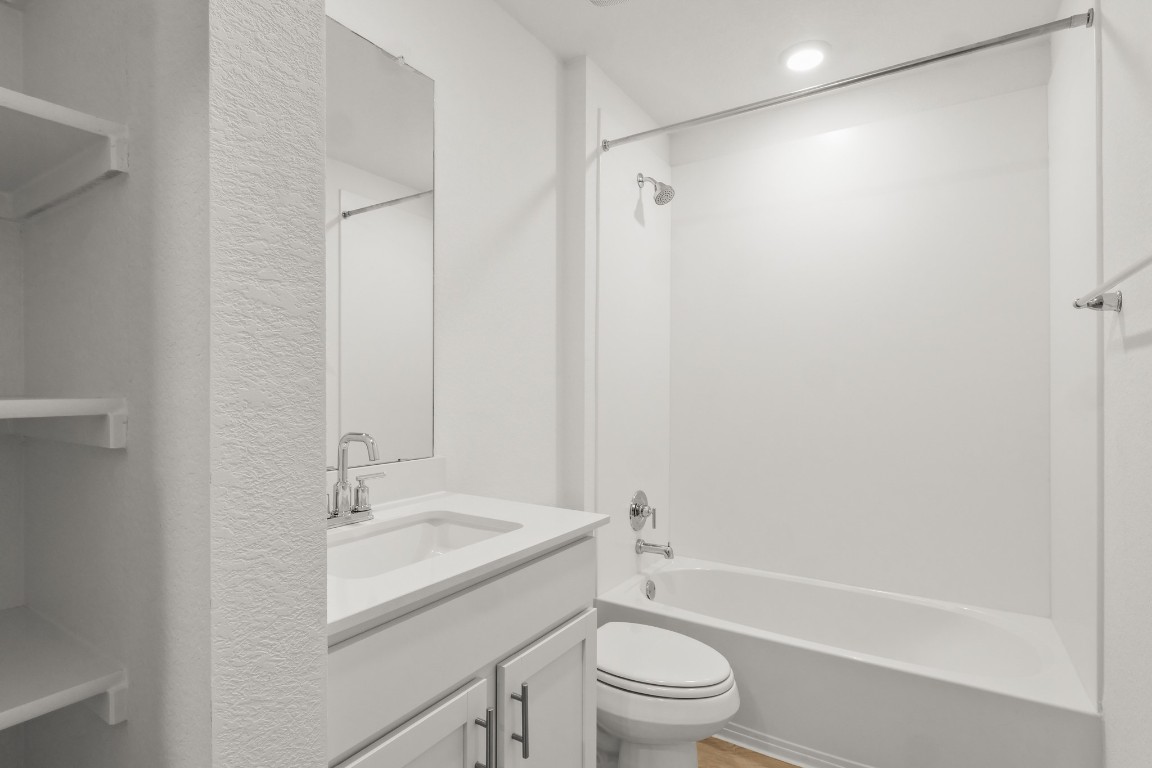 2408 Bronc Buster Way Leander, TX 78641 - Photo 7 of 24 a bathroom with a sink toilet and shower