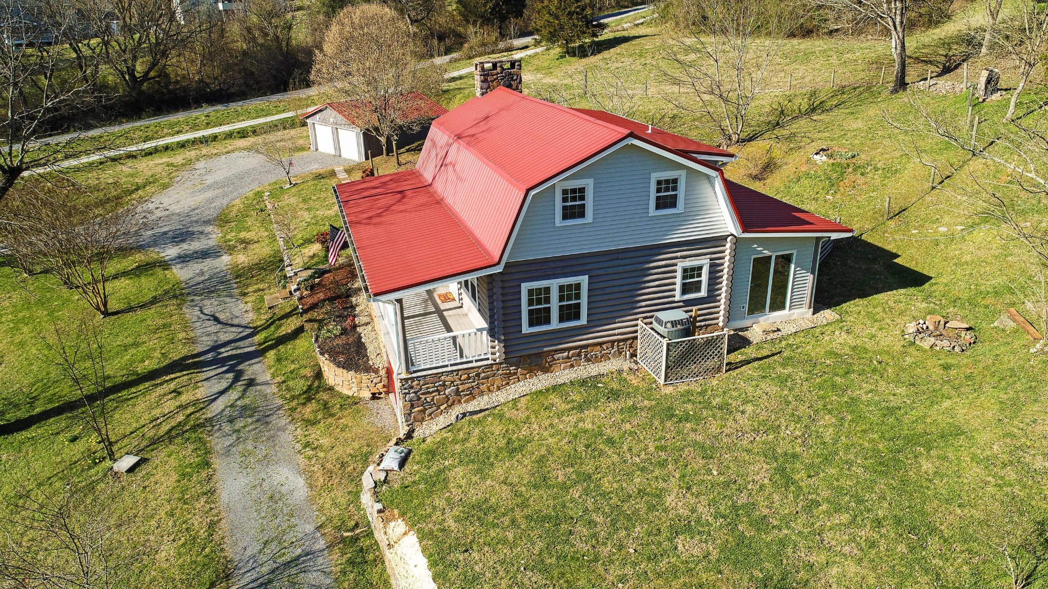 175 Old Andersonville Pike Heiskell, TN 37754 - Photo 8 of 35 a backyard of a house with large trees and wooden fence
