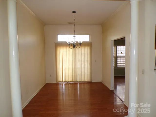 a view of a room with wooden floor and window