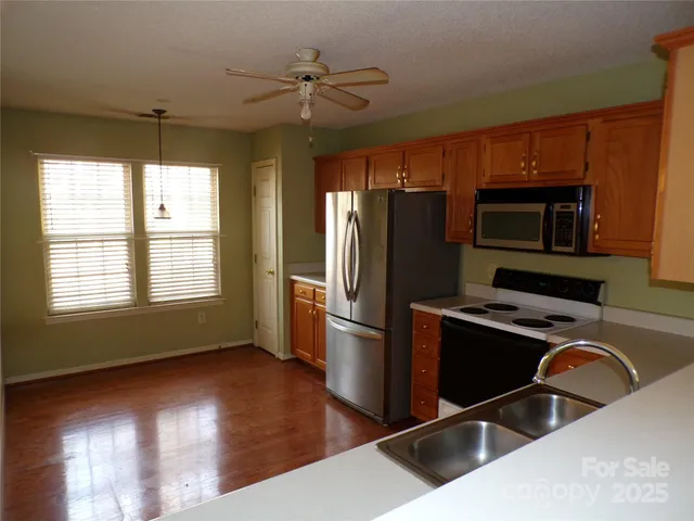 a kitchen with wooden cabinets and stainless steel appliances