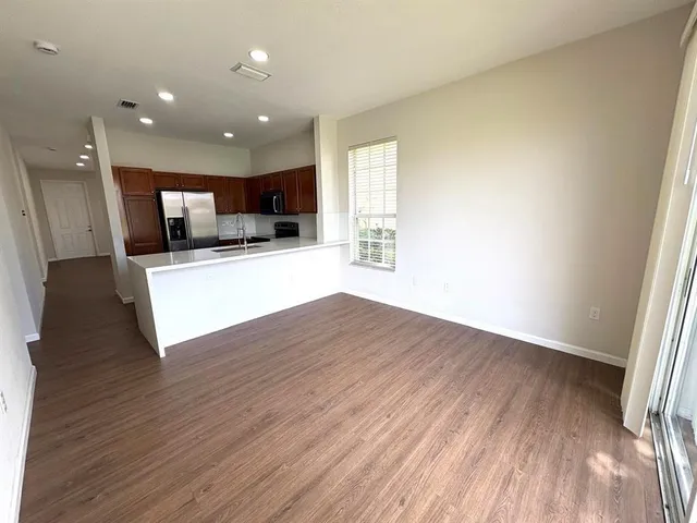 a view of a kitchen with a sink and a stove top oven