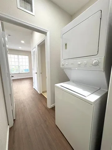 a view of washer and dryer with wooden floor